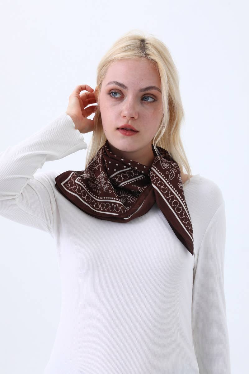 Woman wearing a brown patterned scarf on a white background