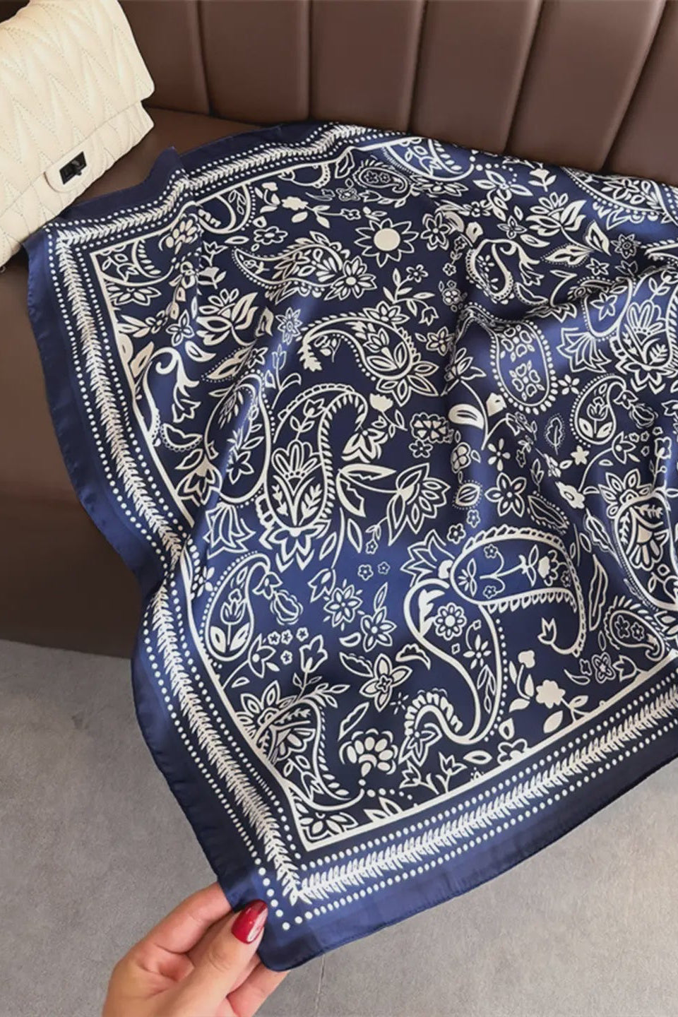 Blue and white patterned bandana on a brown couch
