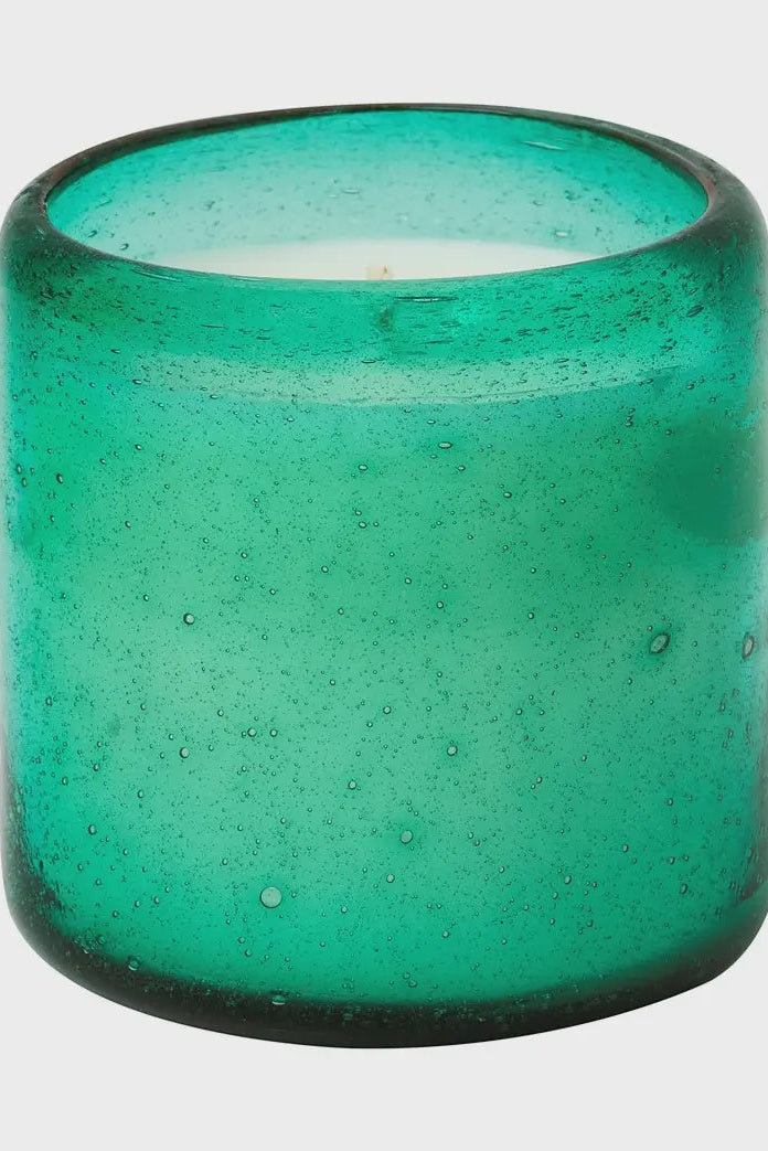 Green glass candle holder on a white background