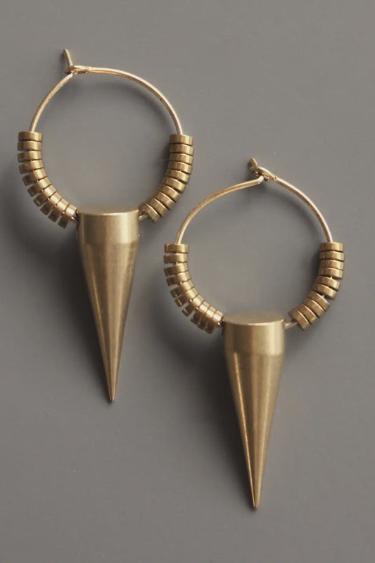 Pair of gold hoop earrings with cone-shaped drops on a gray background
