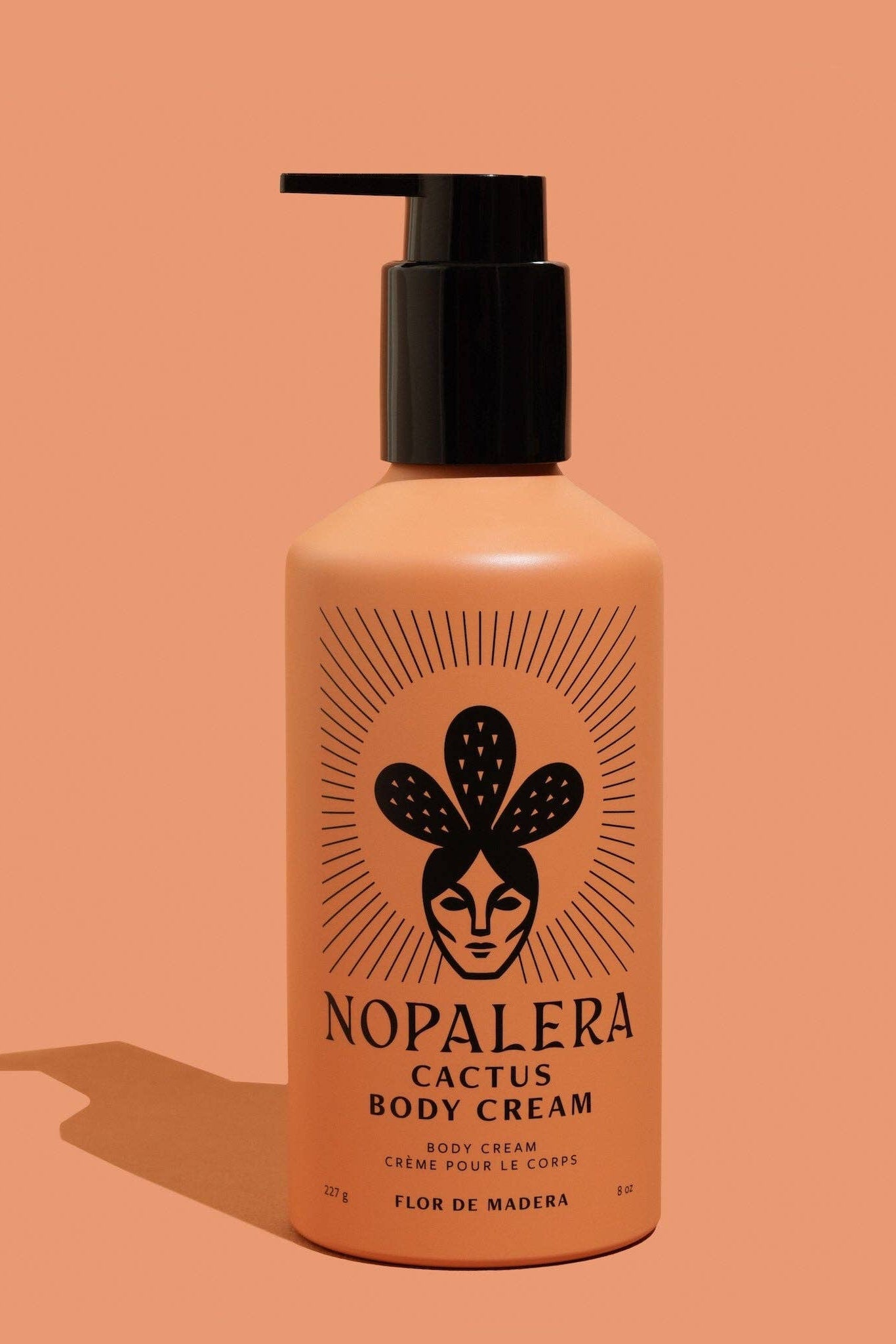 Nopalera cactus body cream bottle on a peach background