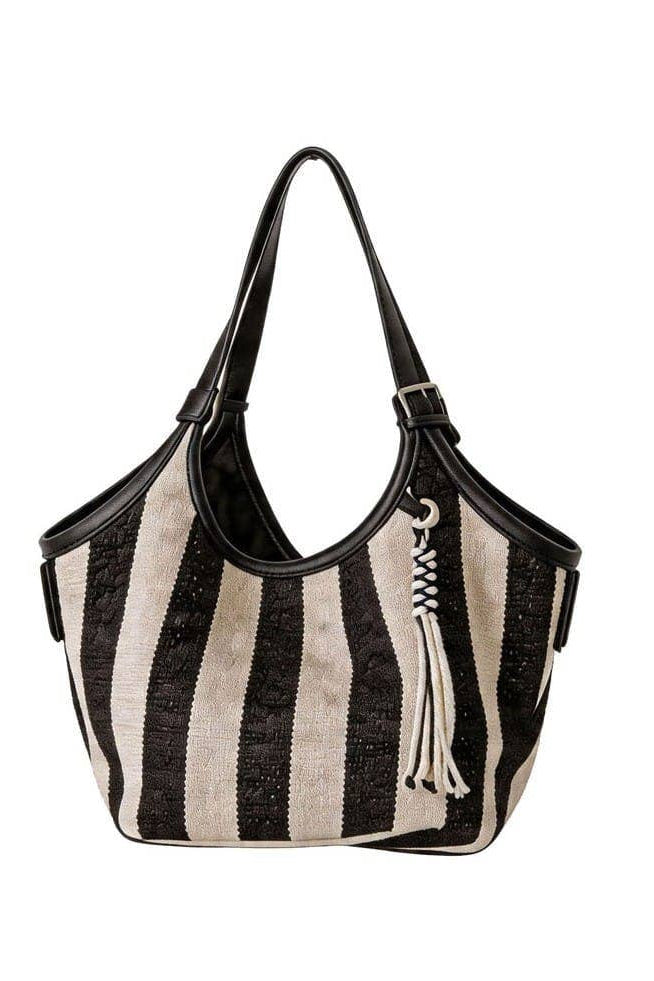 A black and cream striped woven shoulder bag with black leather trim, double shoulder straps, and a decorative white tassel charm, shown against a plain white background.