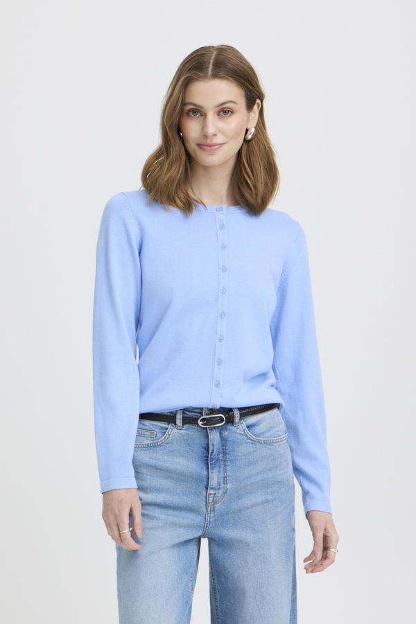 Woman wearing a light blue shirt and jeans on a white background