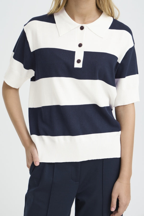 Person wearing a navy and white striped polo shirt on a plain background