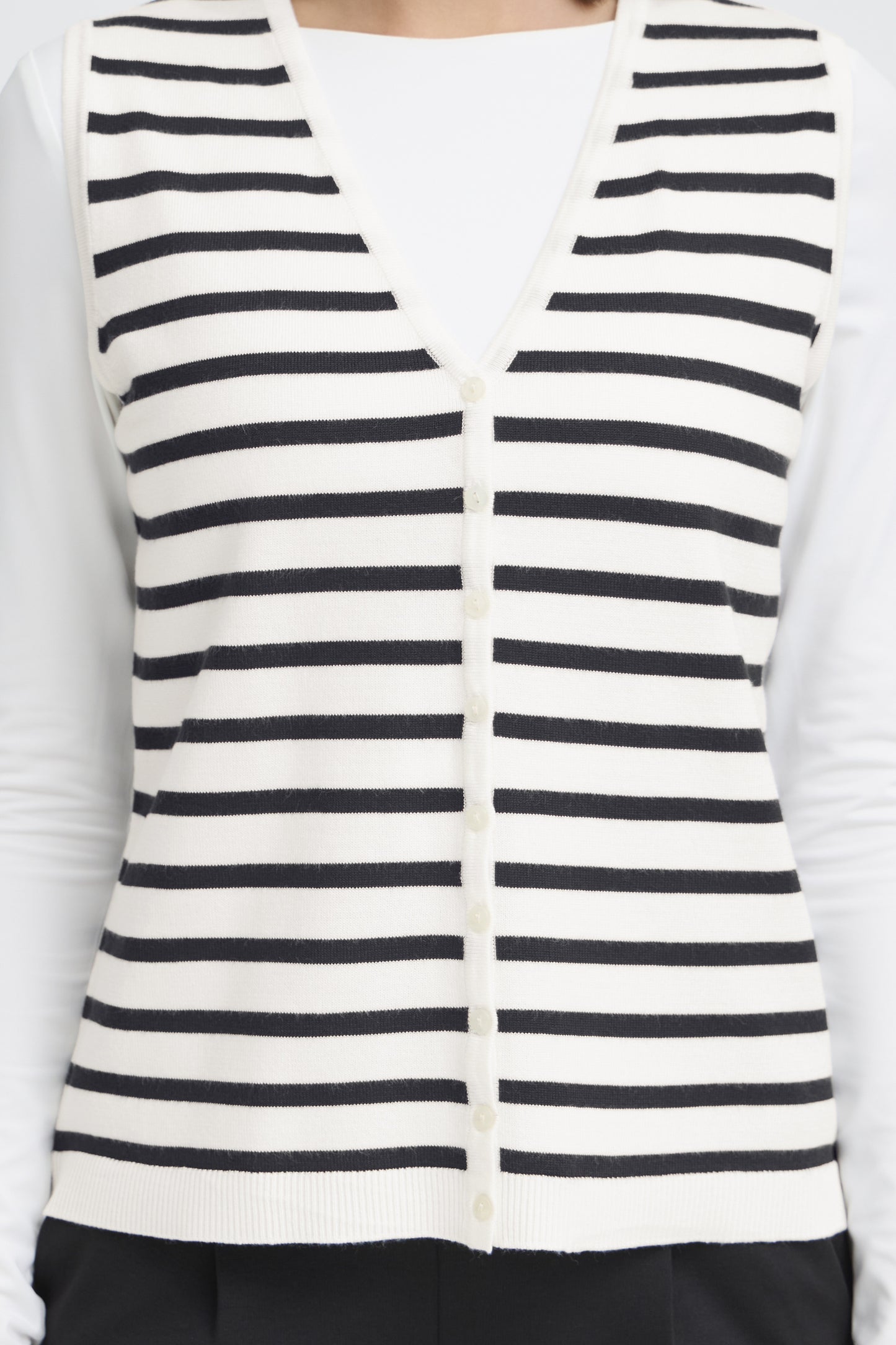Black and white striped vest over a white shirt