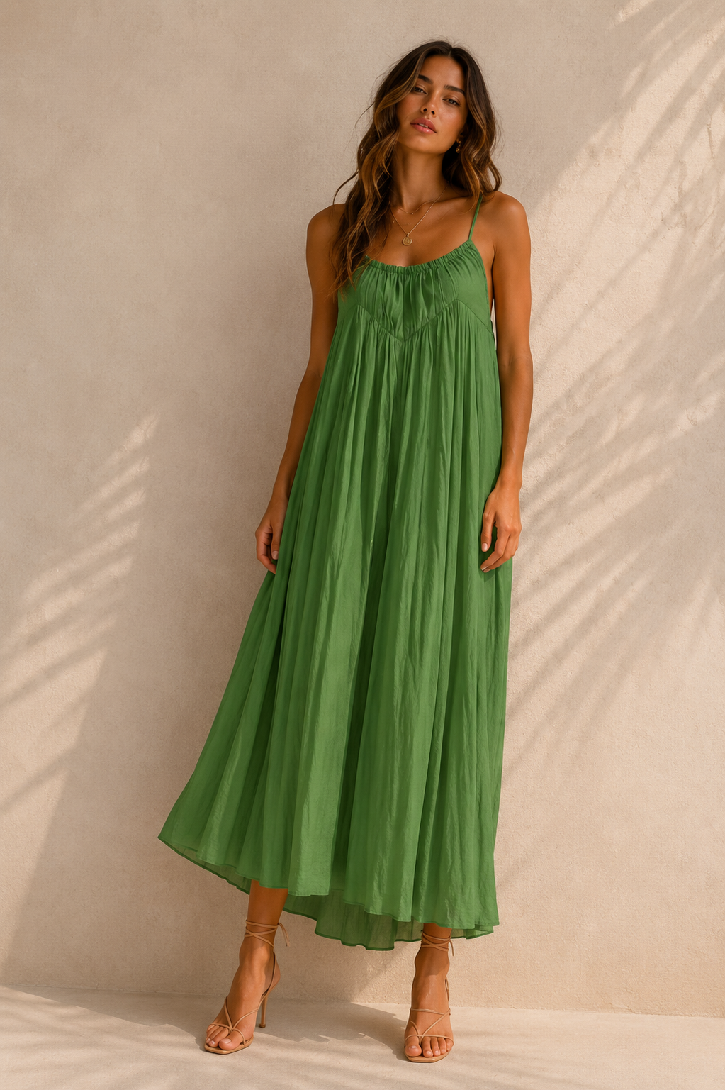 Woman wearing a green dress against a beige background