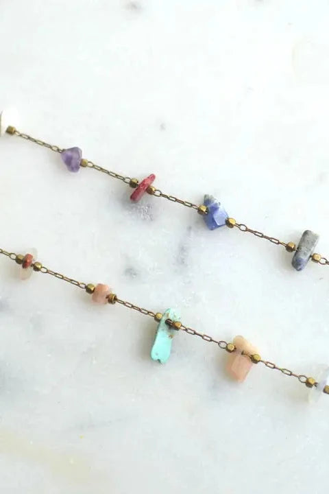 Necklace with multicolored beads on a marble surface