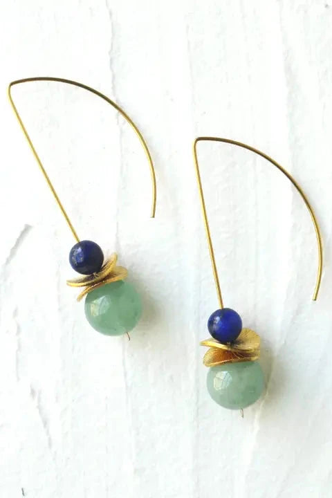 Pair of earrings with green beads and gold accents on a white background