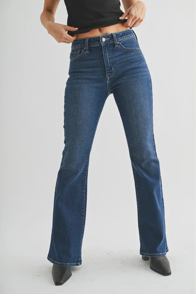 Person wearing blue jeans on a white background