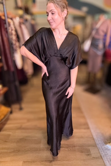 Woman wearing a black dress in a store setting