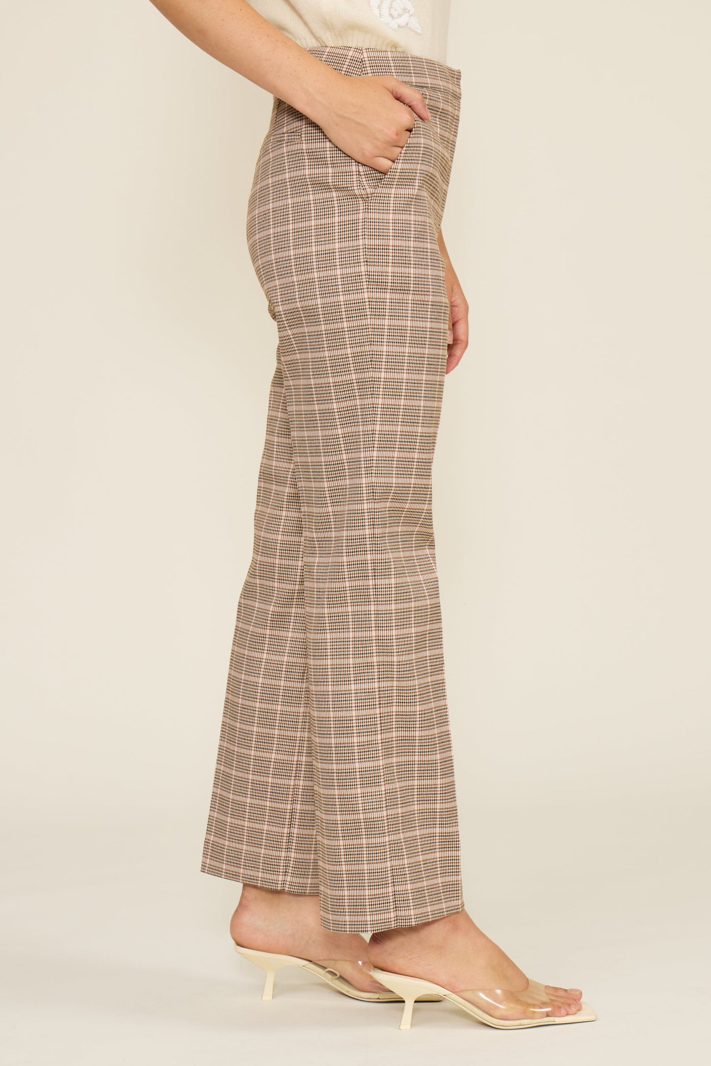 Plaid pants worn by a person on a plain background