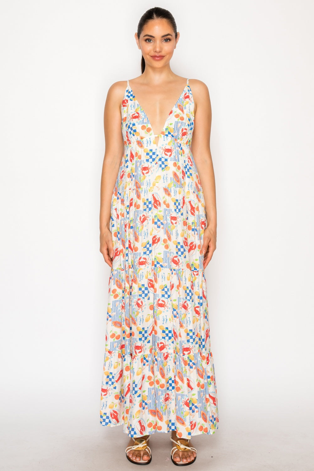 Woman wearing a colorful patterned dress on a white background