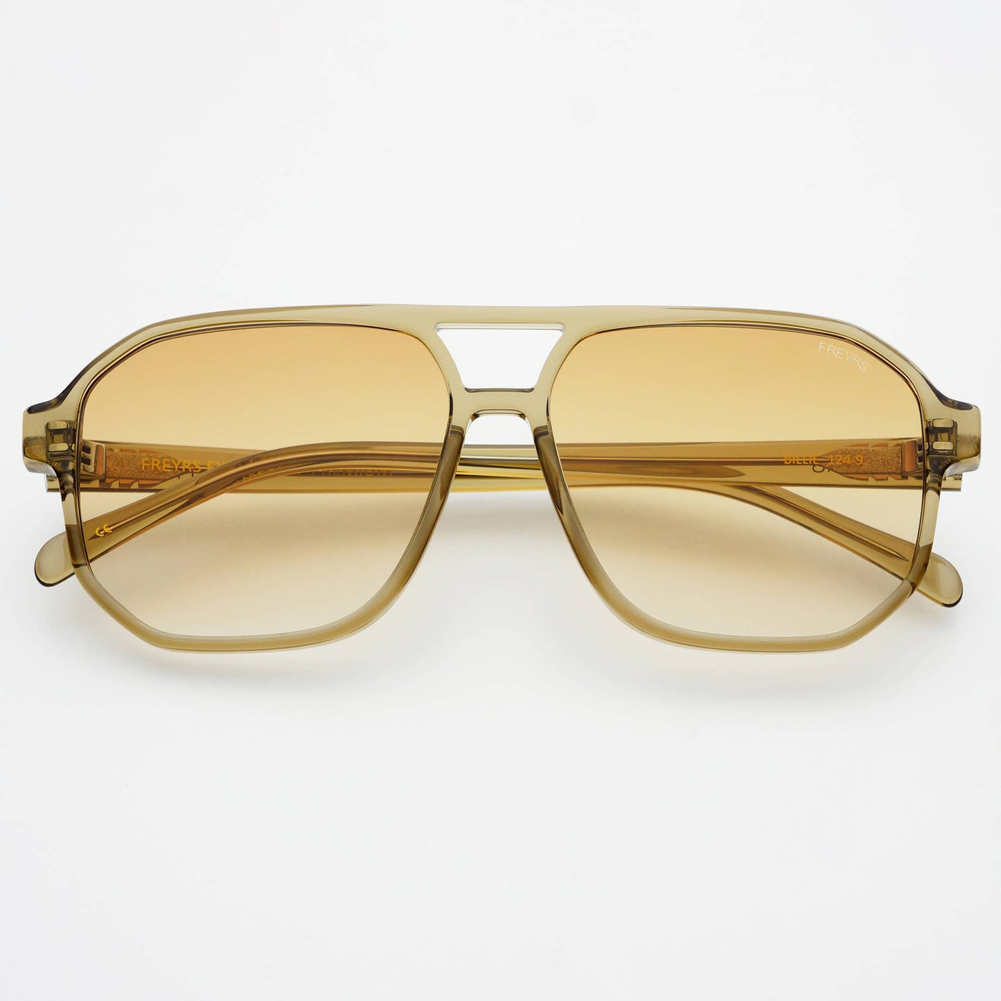 Gold-framed sunglasses with yellow-tinted lenses on a white background