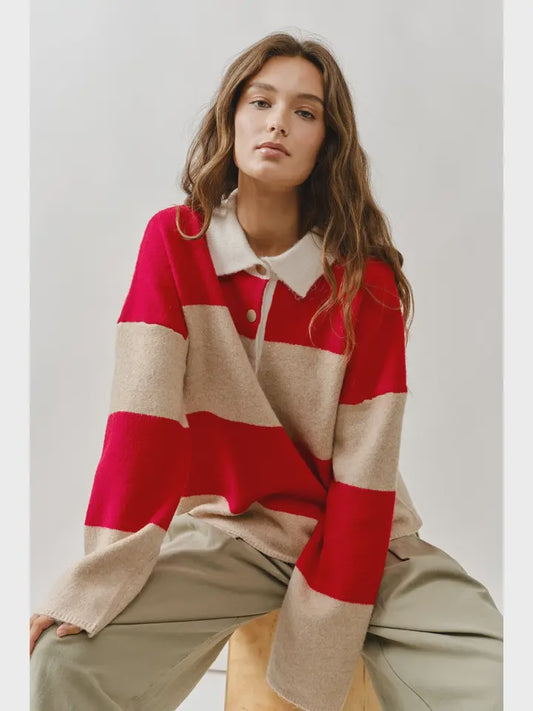 Woman wearing a red and beige striped sweater with a white collar.