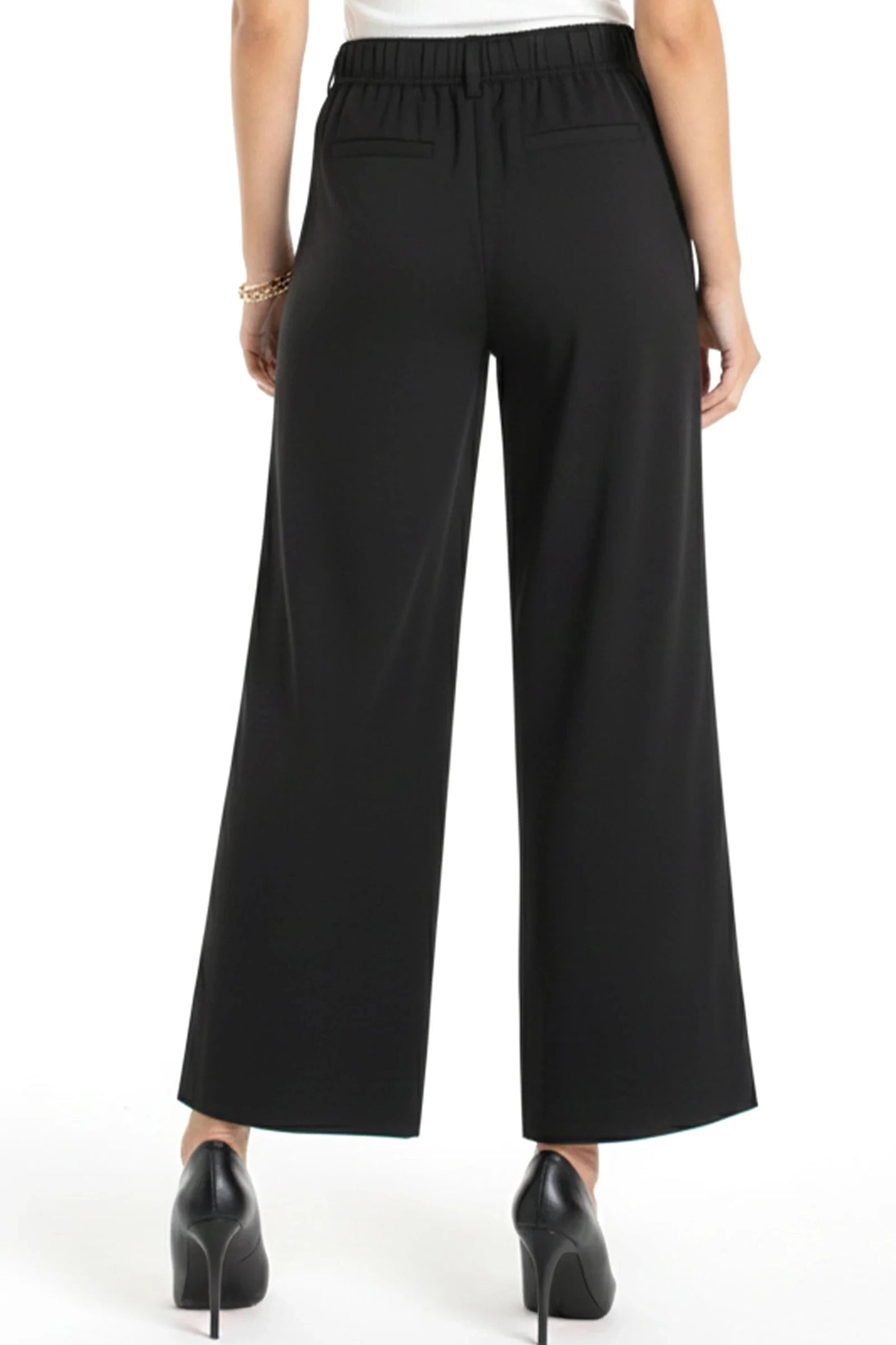 Black wide-leg pants worn by a person on a white background