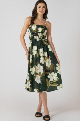 Woman wearing a green floral dress on a white background