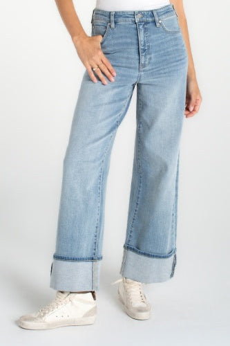 Light blue jeans worn by a person on a white background