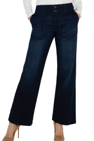 Dark blue jeans worn by a person on a white background