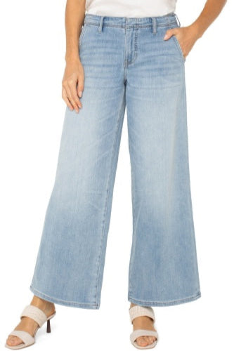 A pair of relaxed fit, wide leg, light wash blue denim jeans with a mid-rise waist and a set-in waistband.