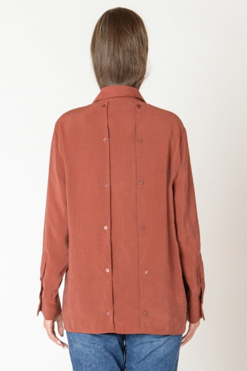 Person wearing a brown jacket with a white background