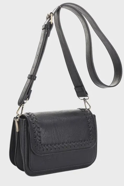 Black handbag with a strap on a light gray background
