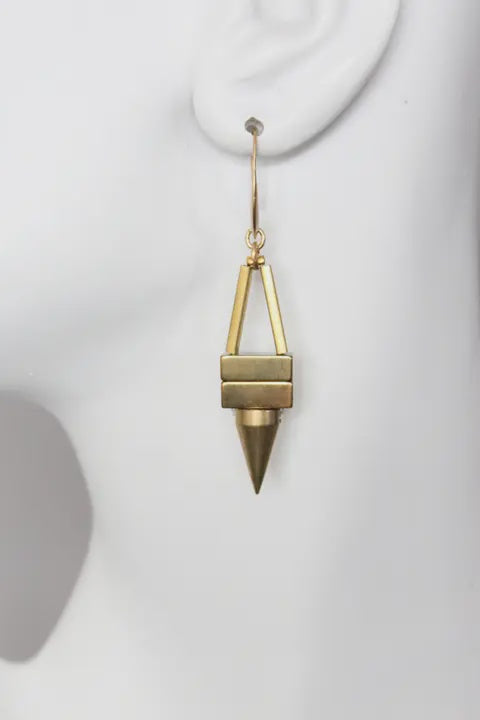 Gold geometric earring on a white background