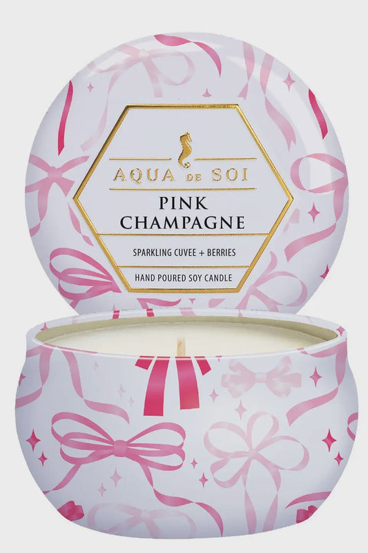 Aqua de Soi Pink Champagne candle with pink ribbon design on a light gray background