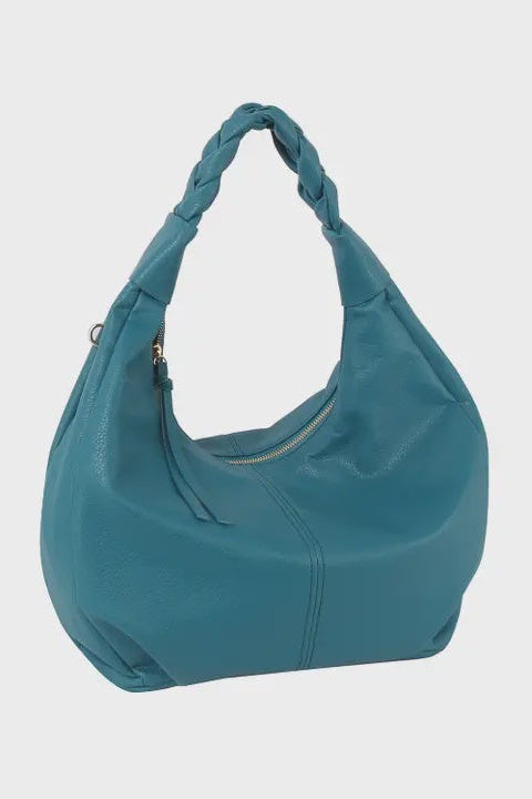 Teal handbag on a light gray background