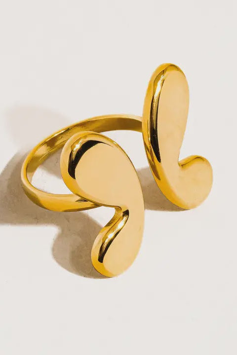 Gold spiral ring on a light background