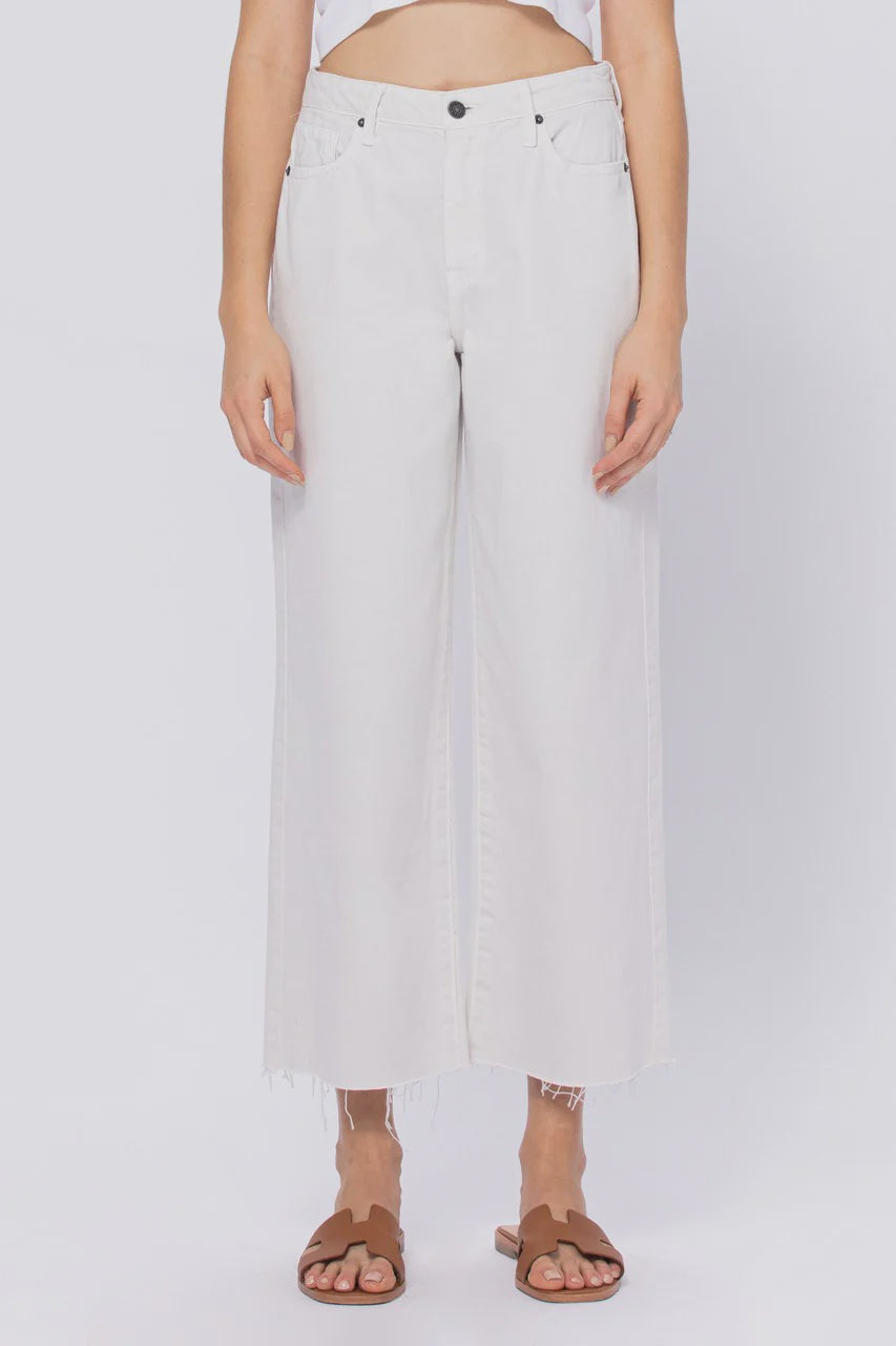 Person wearing light-colored pants on a white background