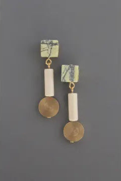 Pair of earrings with geometric shapes on a gray background