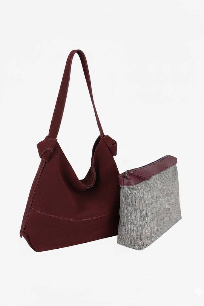 A burgundy fabric shoulder bag with a matching zippered pouch, displayed on a clean white background.