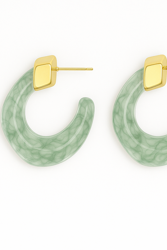 Green hoop earrings with gold posts on a white background