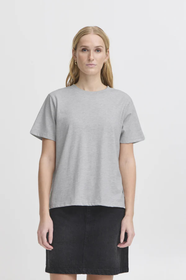 Woman wearing a gray t-shirt and black skirt on a white background