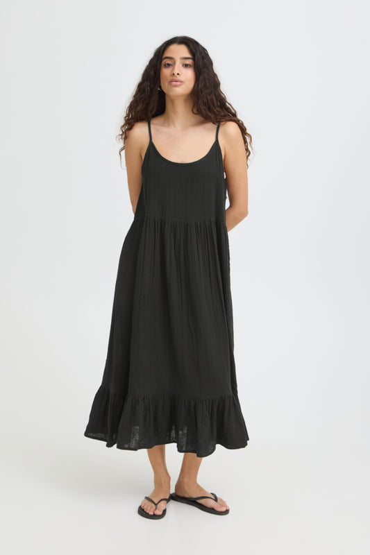 Woman wearing a black dress on a white background