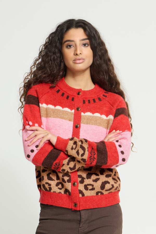 Woman wearing a colorful patterned sweater with a white background