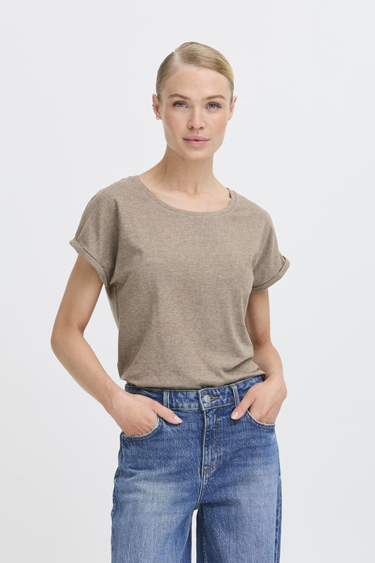 Woman wearing a brown t-shirt and blue jeans on a white background