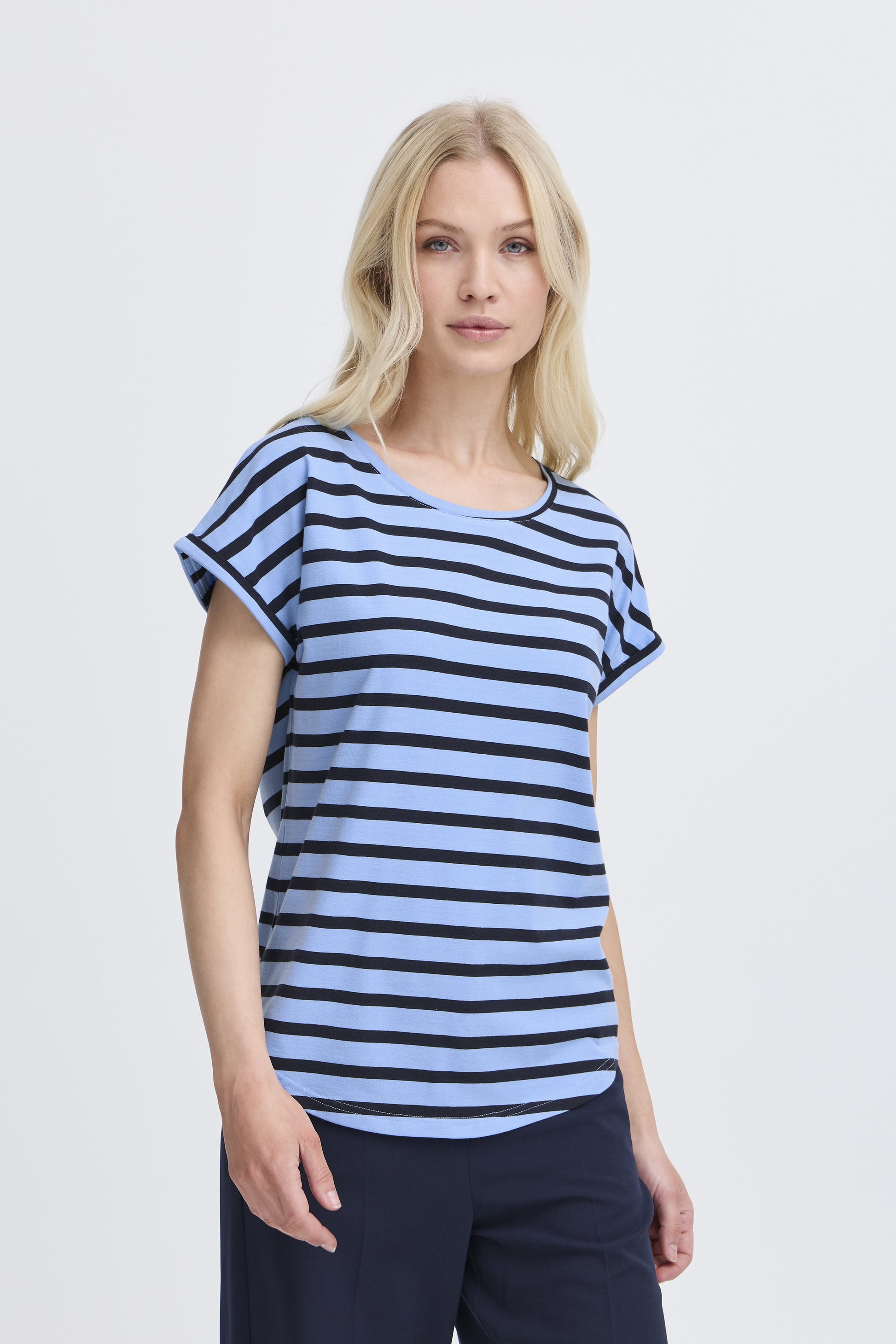 Woman wearing a blue and white striped t-shirt on a light gray background