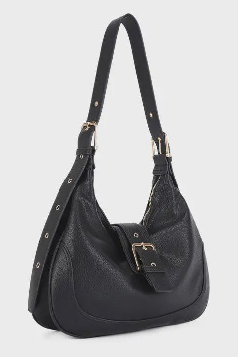 Black handbag with gold accents on a light gray background