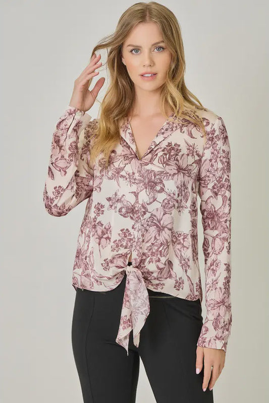 Woman wearing a floral blouse with a plain background