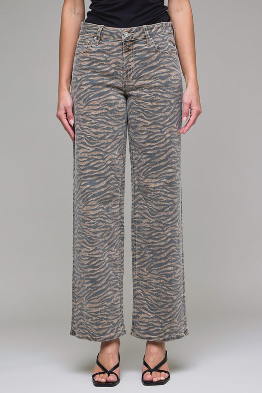 Person wearing zebra print pants on a plain background
