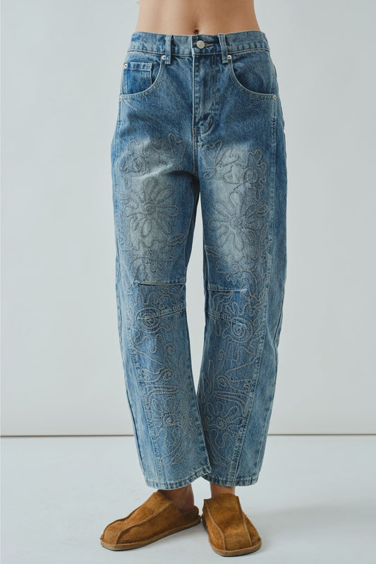 Blue jeans worn by a person on a white background