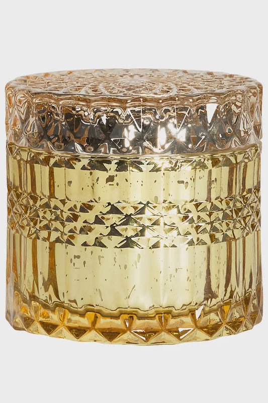 Decorative glass jar with textured design on a light gray background