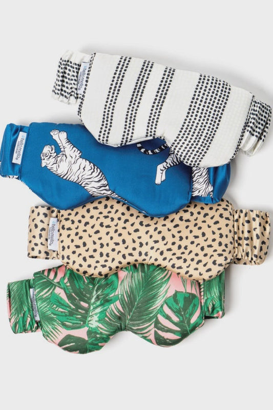 Four colorful baby diapers with different patterns on a light gray background