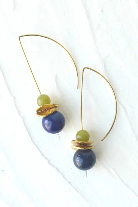 Pair of earrings with blue and green beads on a white background