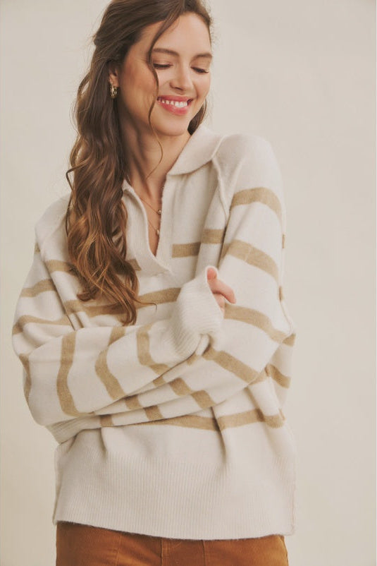 Woman wearing a striped sweater against a plain background