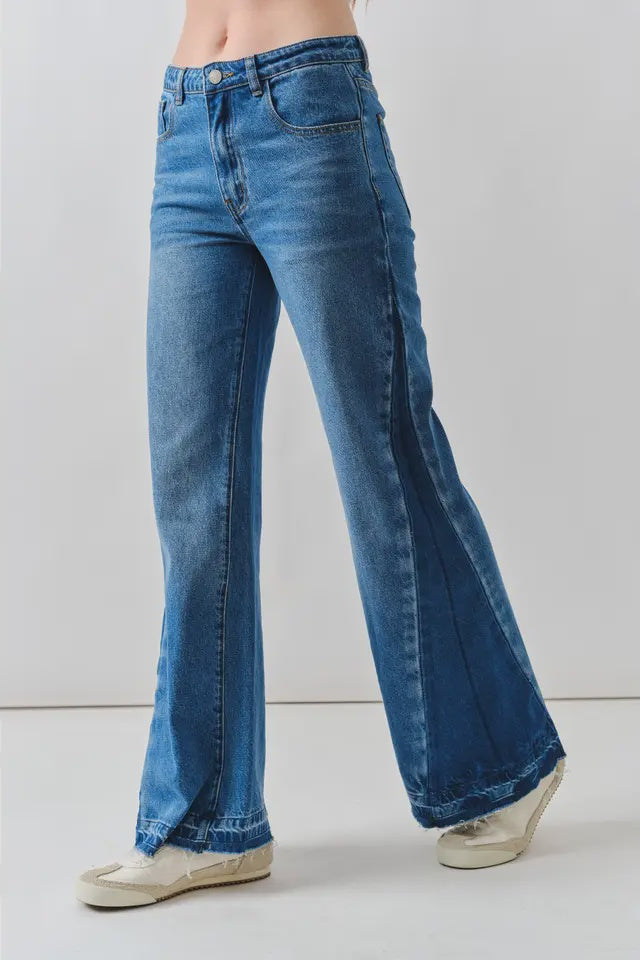 Blue flared jeans on a plain background