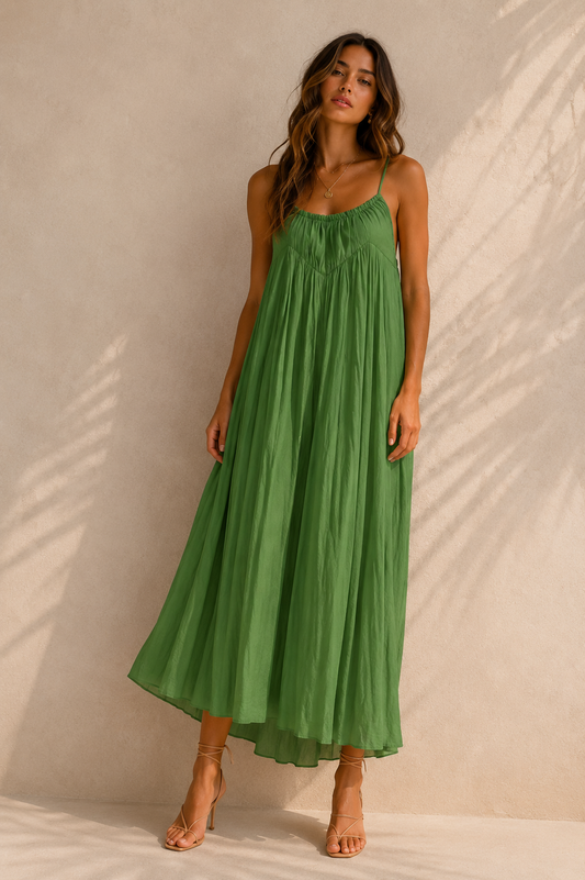 Woman wearing a green dress against a beige background