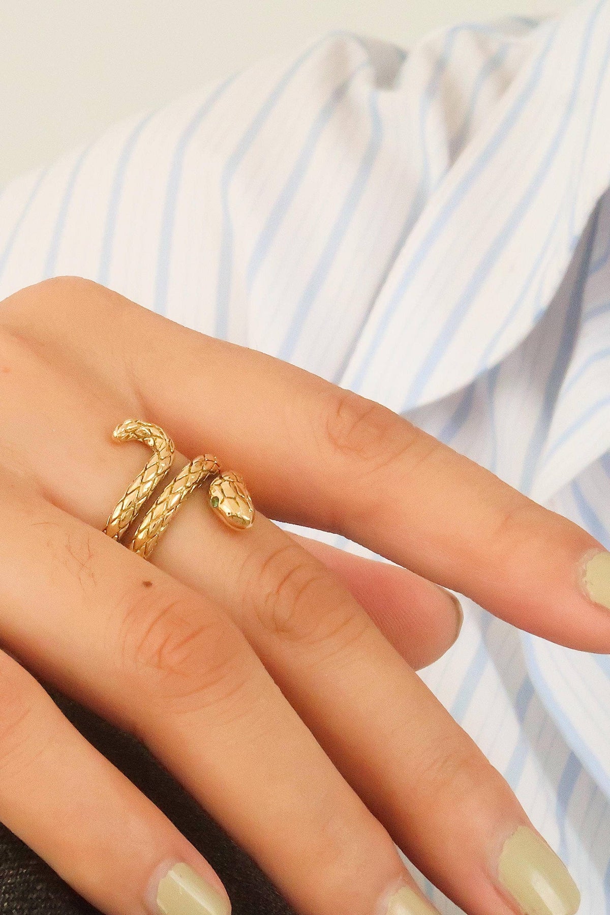 Gold ring on a finger with a blurred background