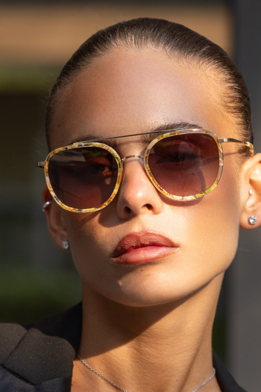 Woman wearing sunglasses with a blurred background